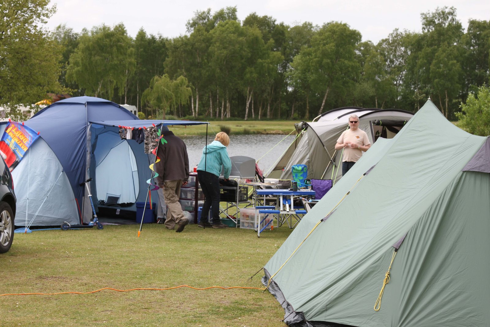 Tents beside the lake at Willow Holt Caravan and Camping Park