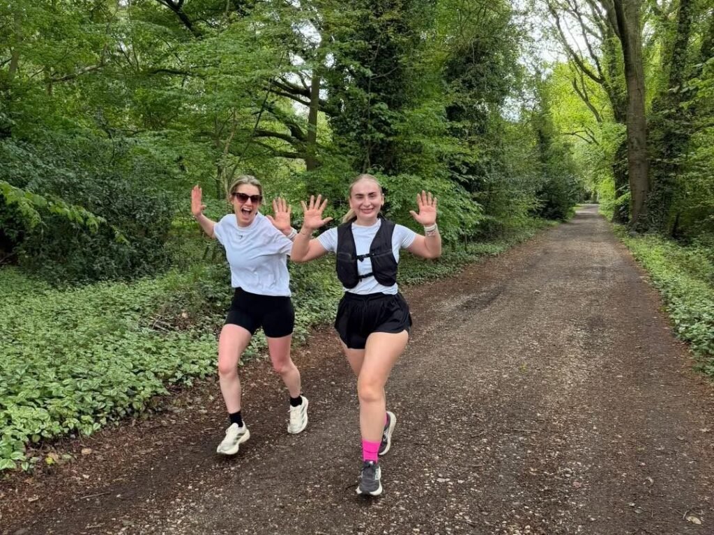 Two 617 Squadron Run Club runners on a tree-lined path in Woodhall Spa