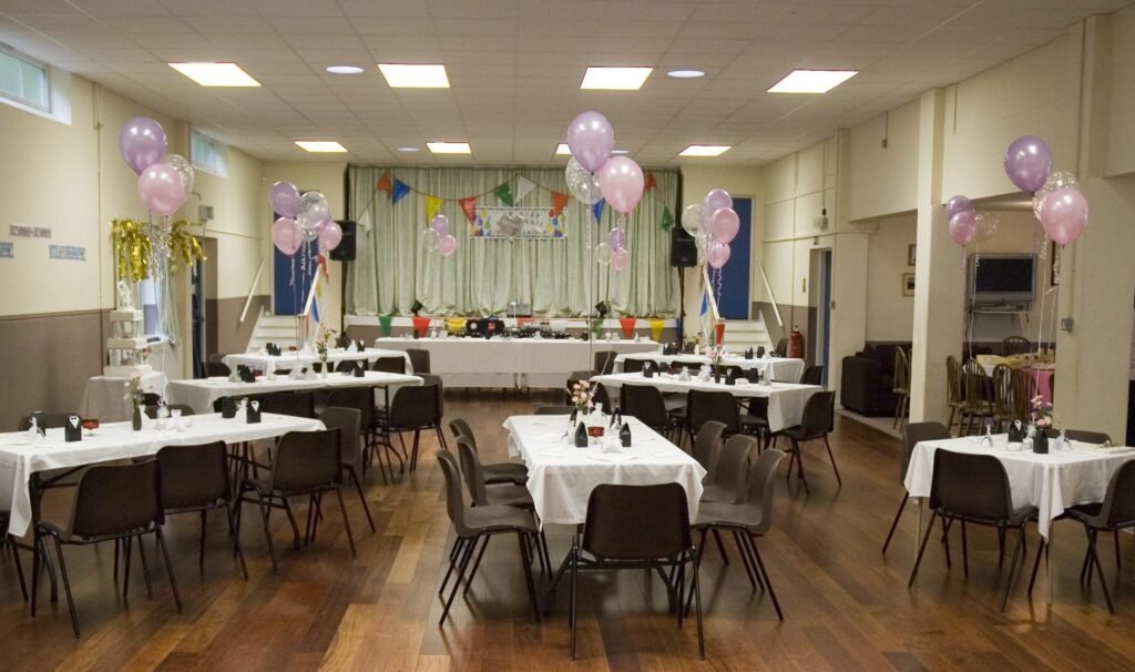 Coronation Hall in Woodhall Spa arranged with tables and chairs for a celebration