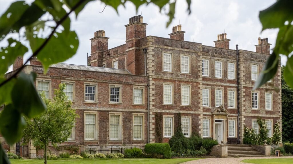 Gunby Hall seen through trees from its gardens