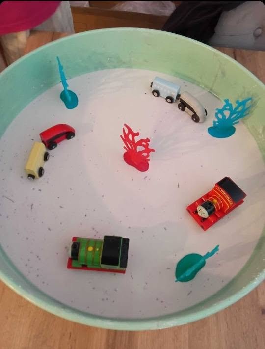 Sensory play tray with toy trains at Little Bambi's in Woodhall Spa