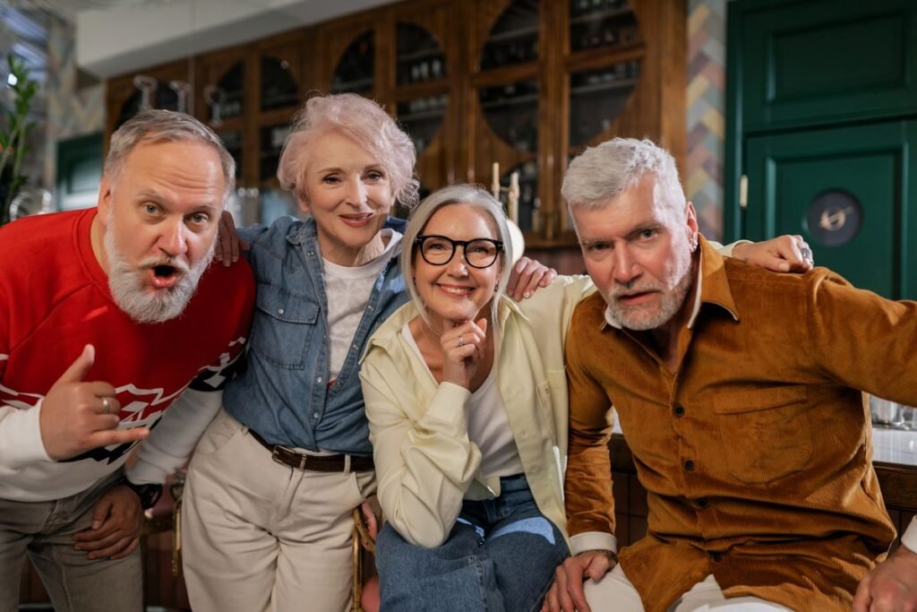 Four older adults enjoying a social gathering indoors; representative friendship photograph