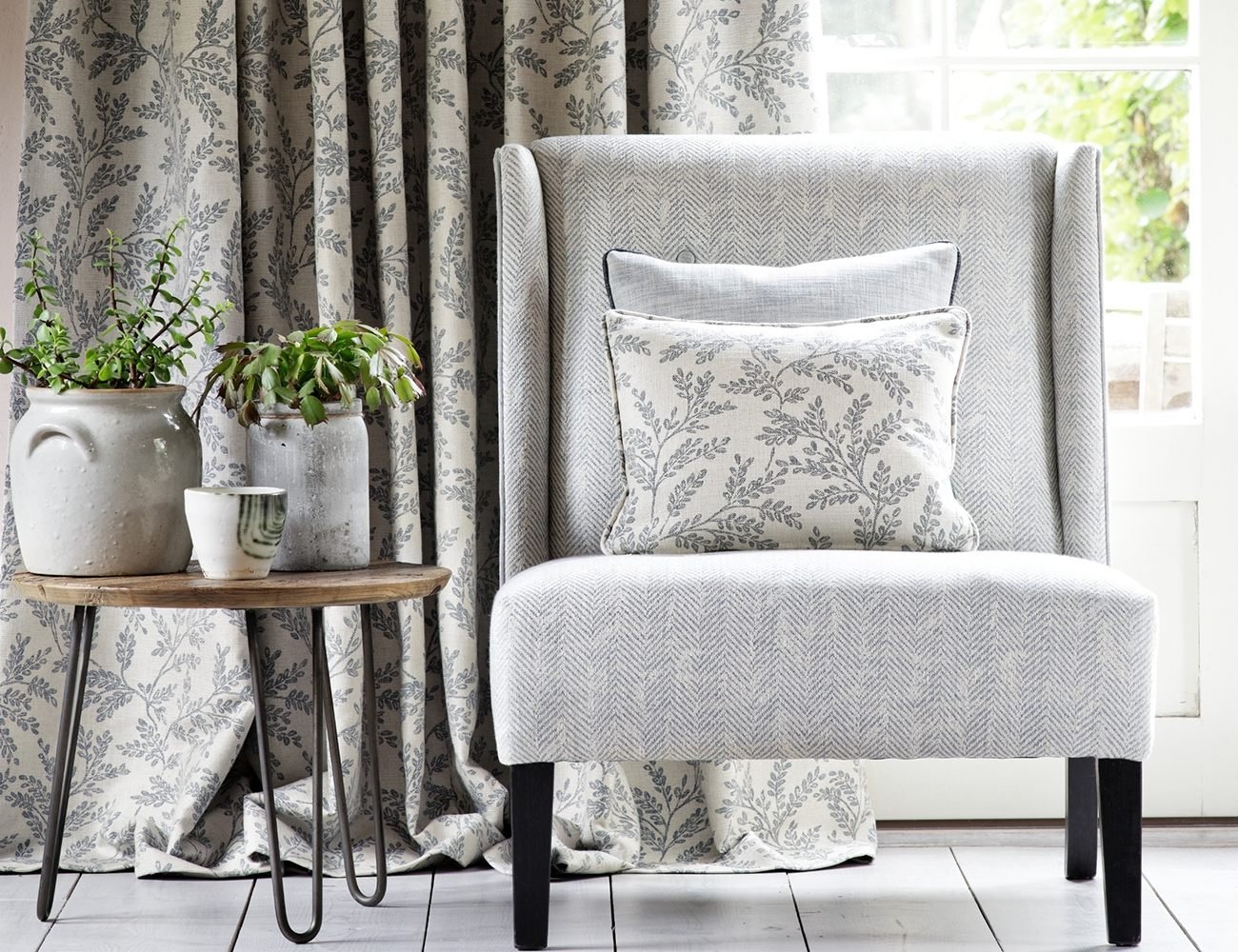 Curtains, cushions and upholstered chair shown by Pin Cushion Interiors