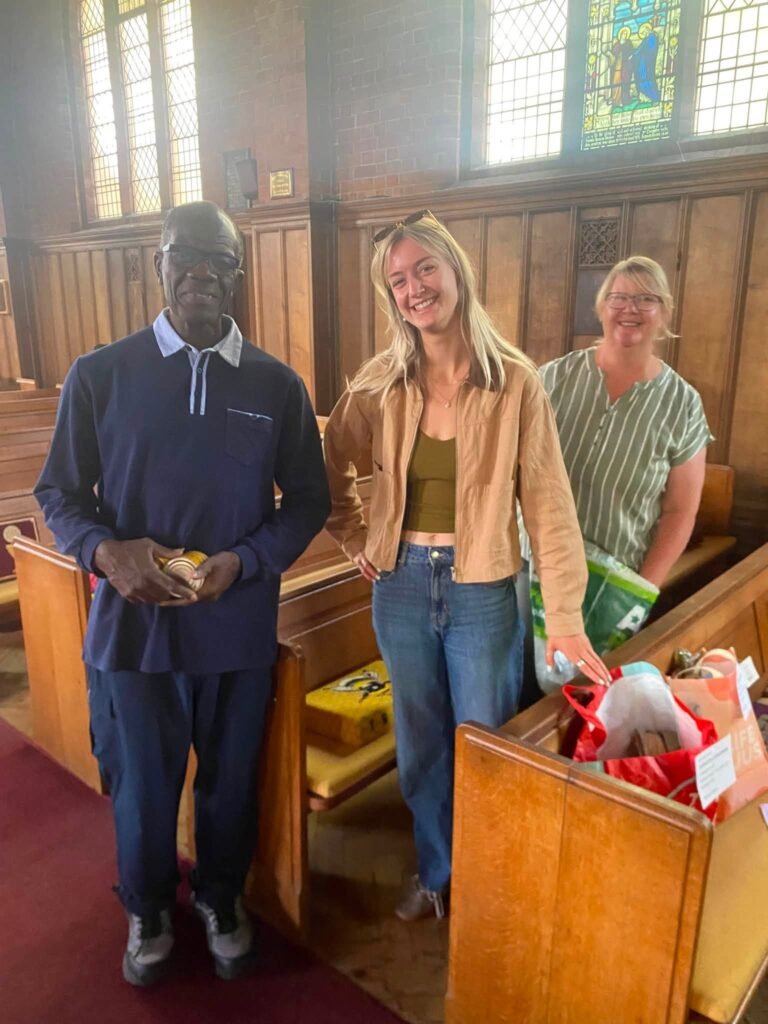 People standing beside donated groceries pictured by Woodhall Spa and Kirkby on Bain Food Bank
