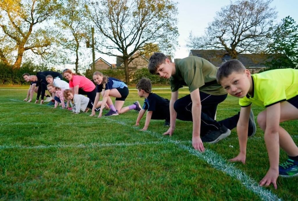 Woodhall Spa Steamers runners practising starts on the grass at a training session