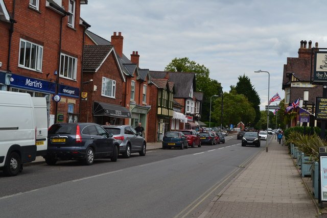 Shops and roadside parking along The Broadway in Woodhall Spa